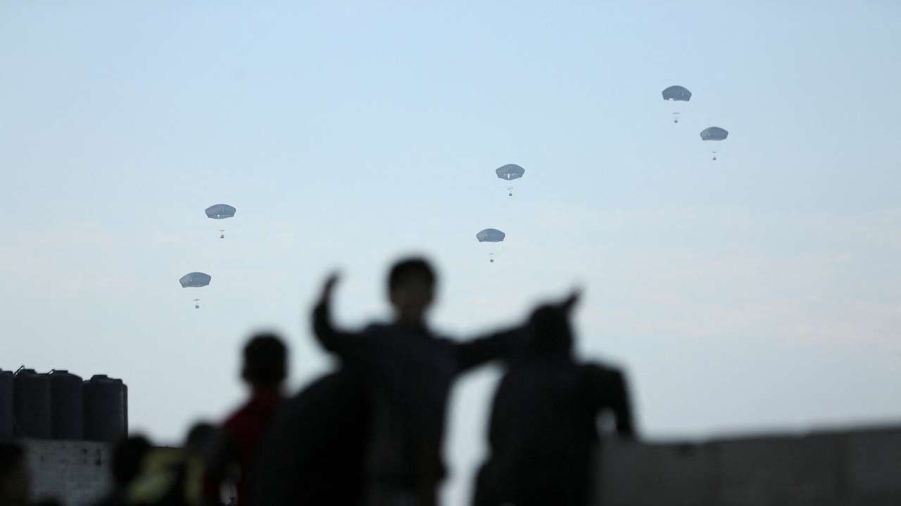 People watch as U.S. military carries out its first aid drop over Gaza, amid the ongoing the conflict between Israel and the Palestinian Islamist group Hamas, in Gaza City
