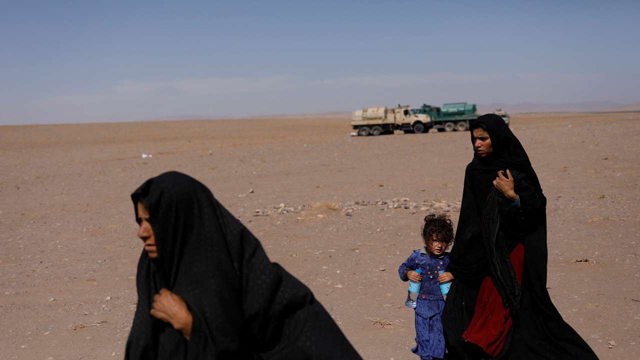 FILE PHOTO: Afghan women walk after the recent earthquake in the district of Zinda Jan, in Herat
