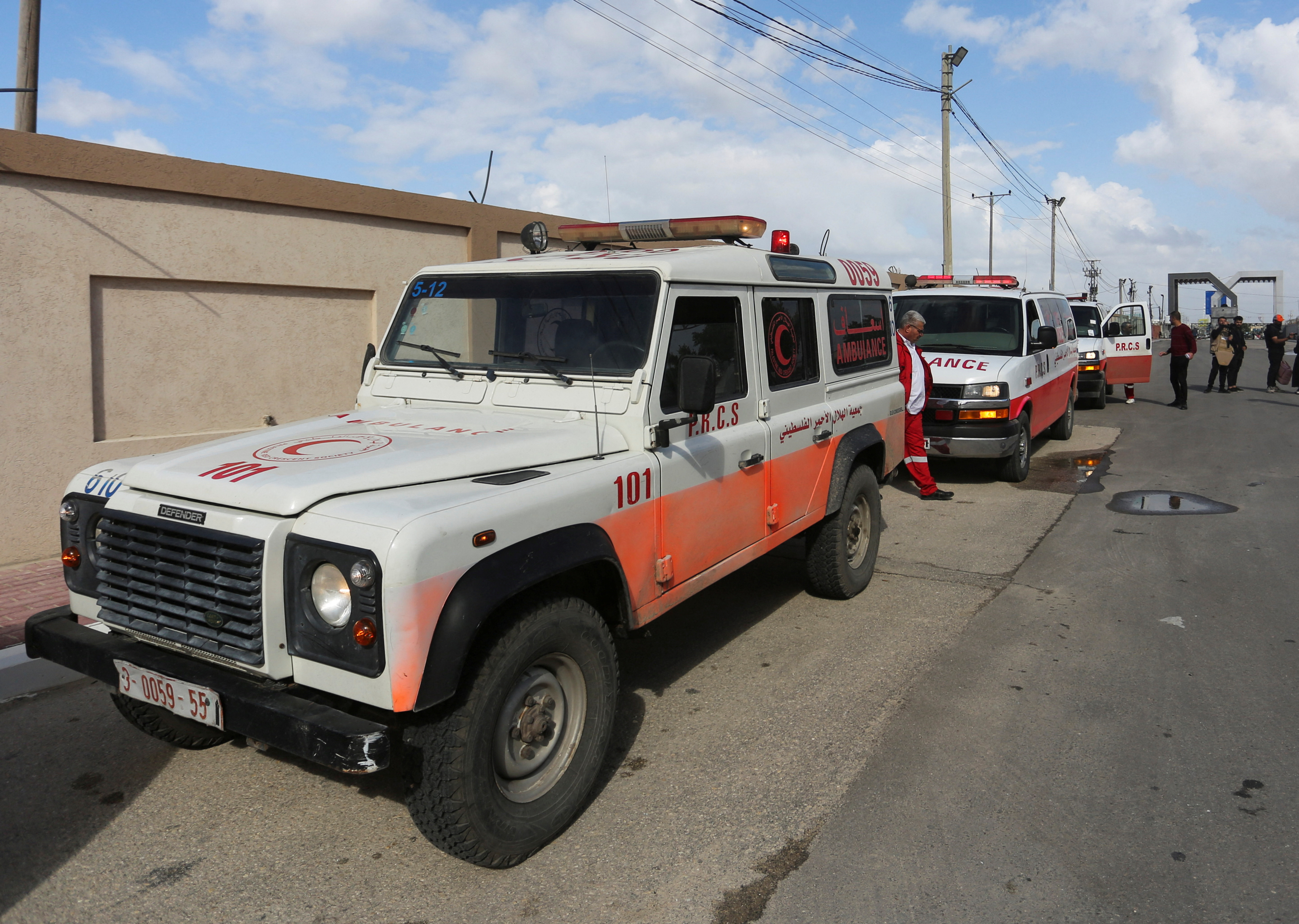 A man walks next to ambulances carrying premature babies, who were evacuated from Al Shifa hospital, before they are transported for treatment in UAE, at Rafah border crossing with Egypt, in Rafah