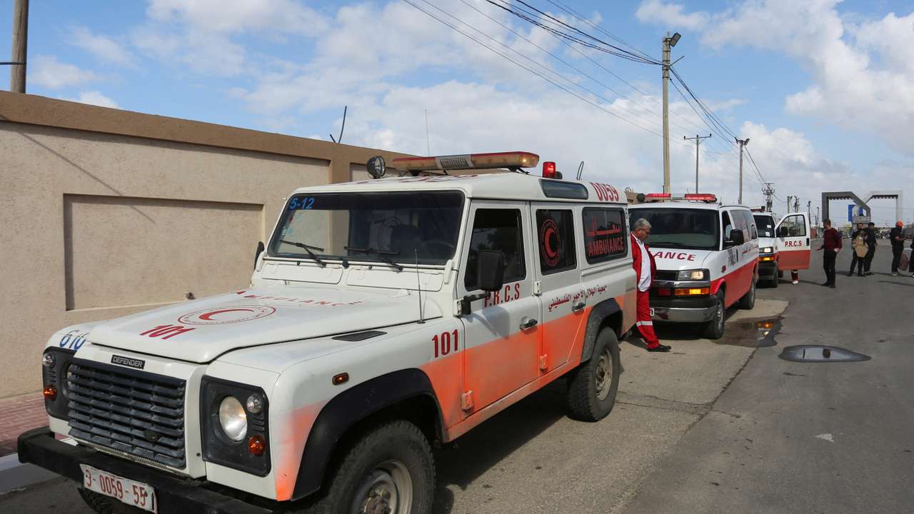 A man walks next to ambulances carrying premature babies, who were evacuated from Al Shifa hospital, before they are transported for treatment in UAE, at Rafah border crossing with Egypt, in Rafah