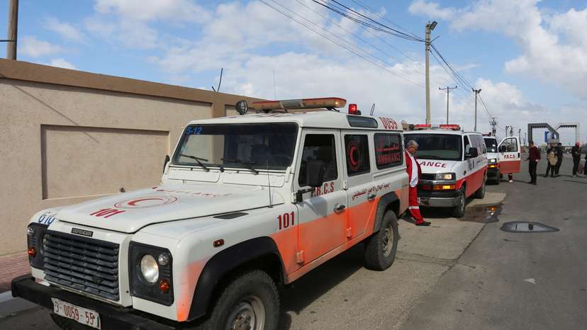 A man walks next to ambulances carrying premature babies, who were evacuated from Al Shifa hospital, before they are transported for treatment in UAE, at Rafah border crossing with Egypt, in Rafah