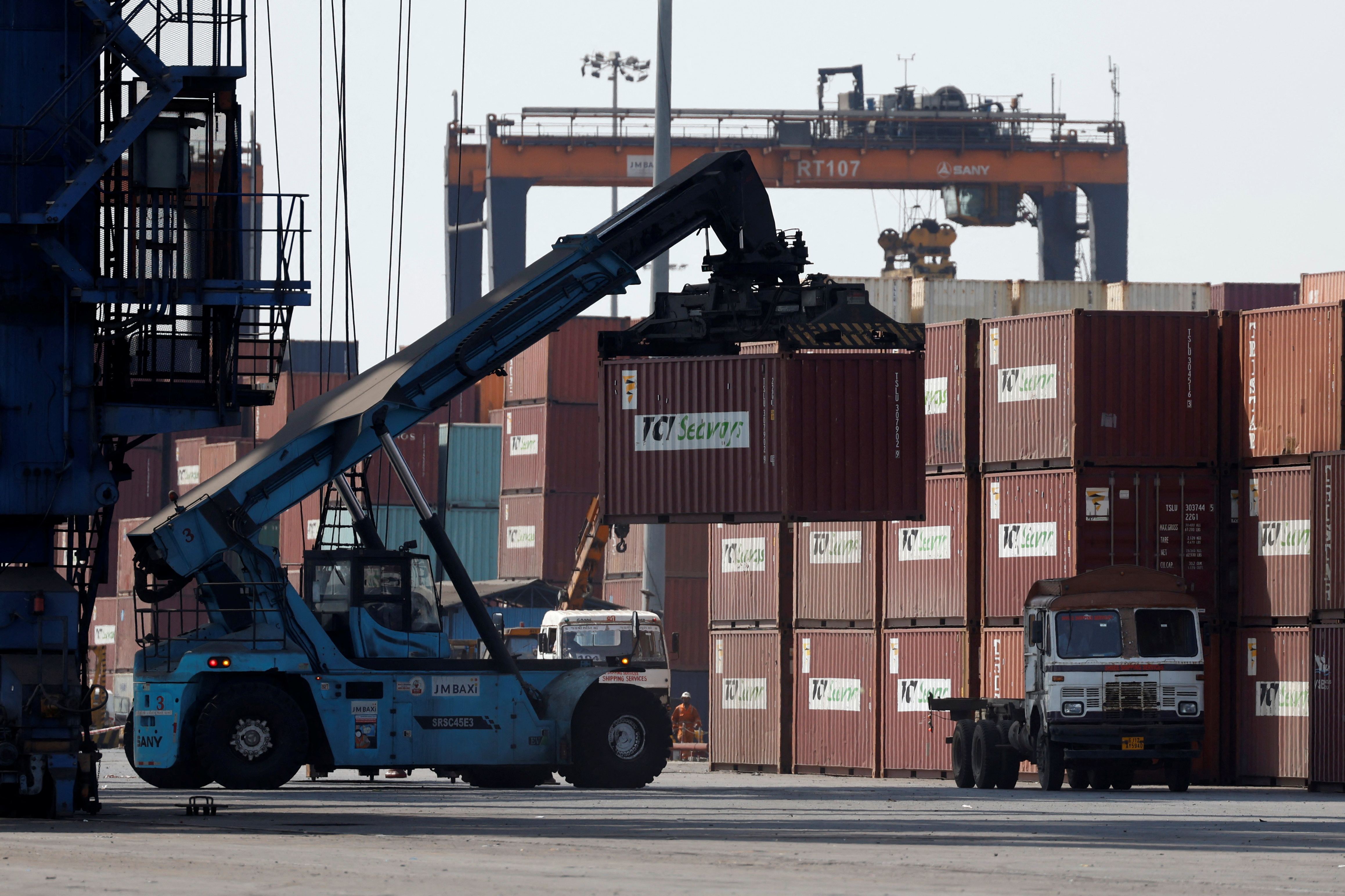 A mobile crane carries a container at Deendayal Port in Kandla