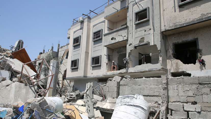 Palestinian Abdel Rahman Barika looks at the site of an Israeli strike, in Rafah