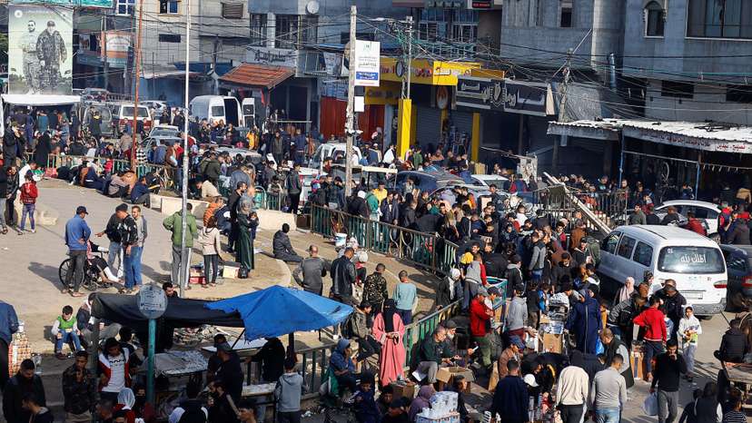 Palestinians shop at a market, in Rafah