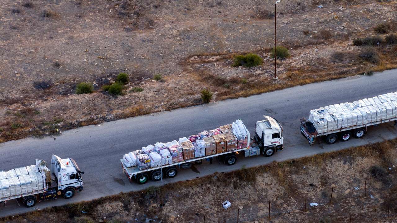 A drone picture of part of a line of trucks waiting on an Egyptian road along the border with Israel, near the Rafah border crossing with the Gaza Strip