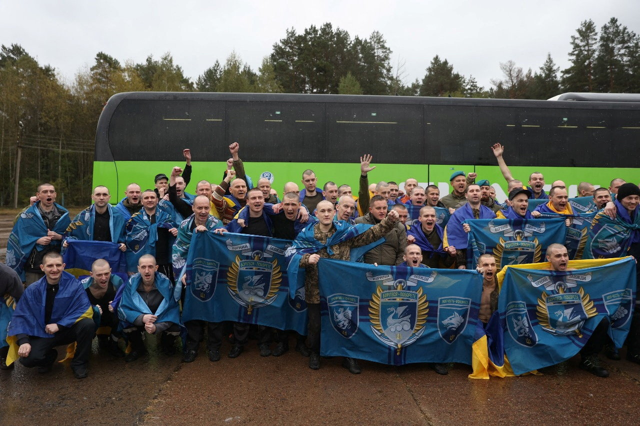 Ukrainian prisoners of war (POWs) gather after a swap at an unknown location in Ukraine