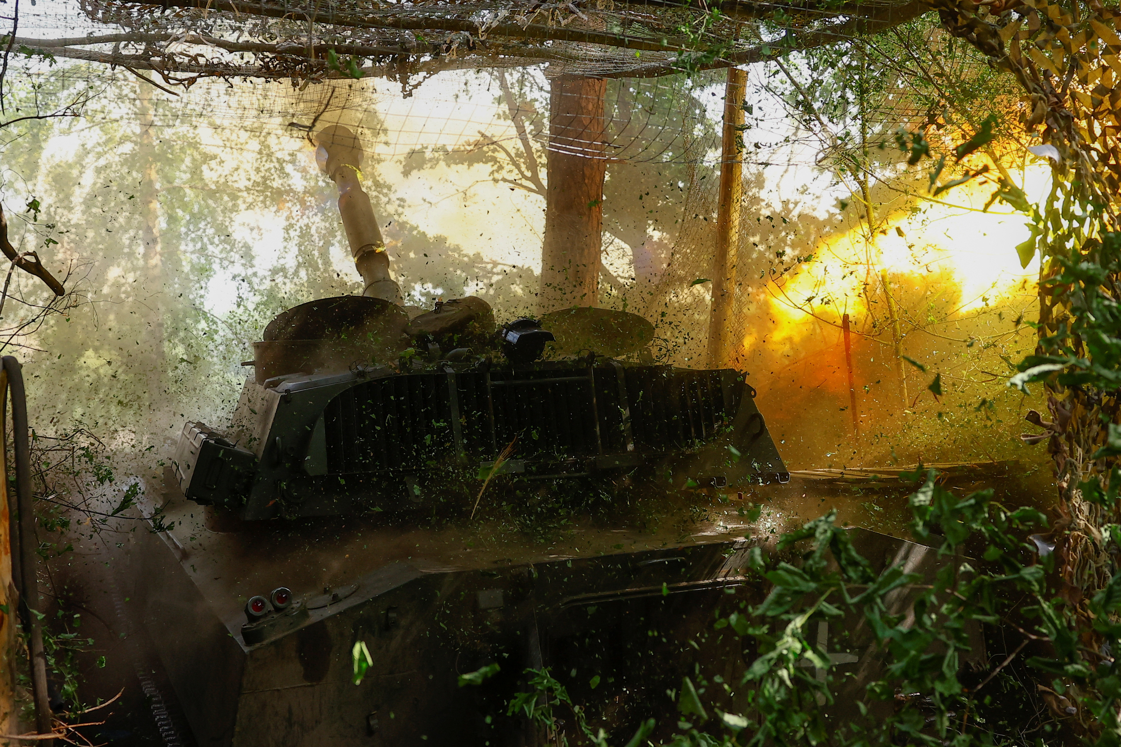 Ukrainian servicemen fire a self-propelled howitzer towards Russian troops in a front line in Kharkiv region