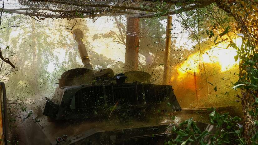 Ukrainian servicemen fire a self-propelled howitzer towards Russian troops in a front line in Kharkiv region