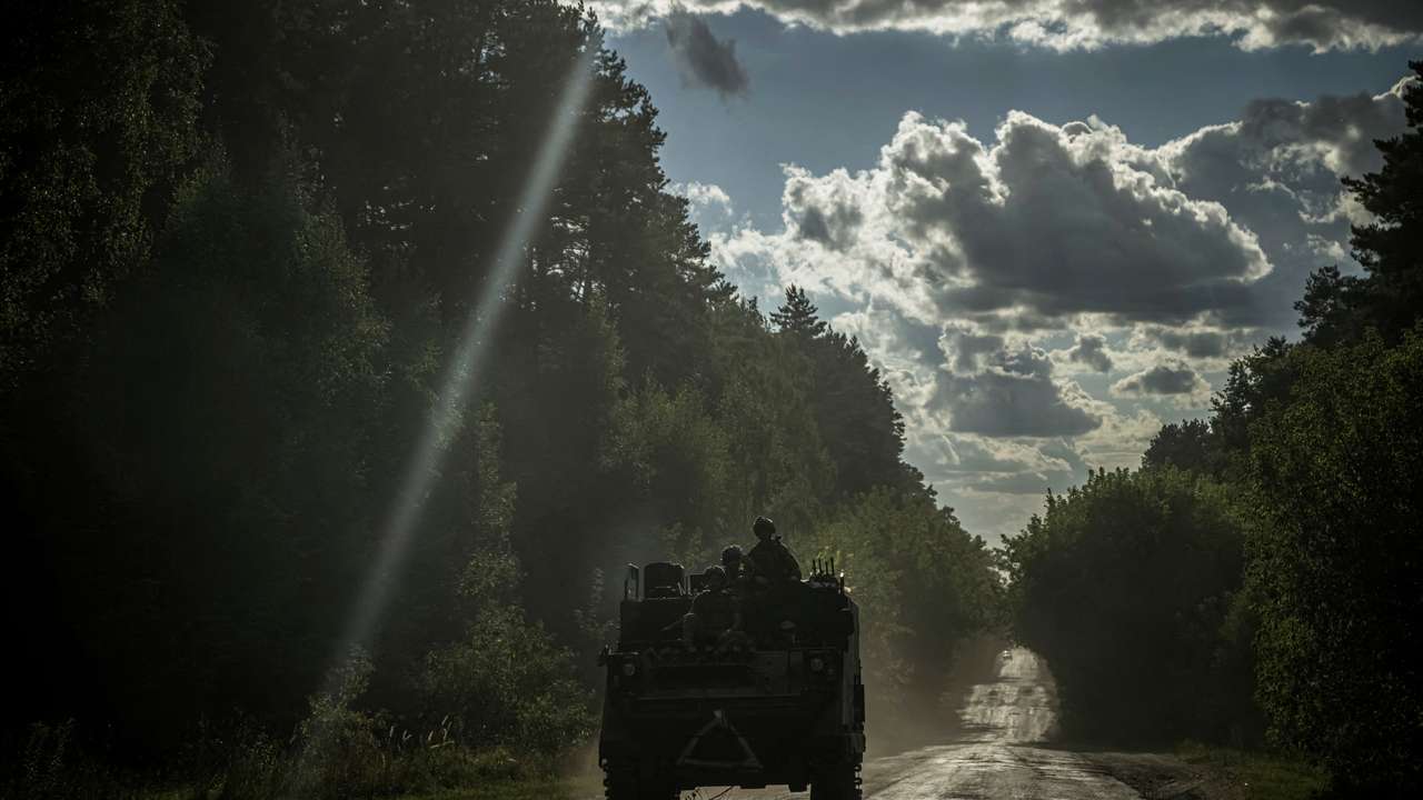 FILE PHOTO: Ukrainian servicemen ride a military vehicle near the Russian border in Sumy region