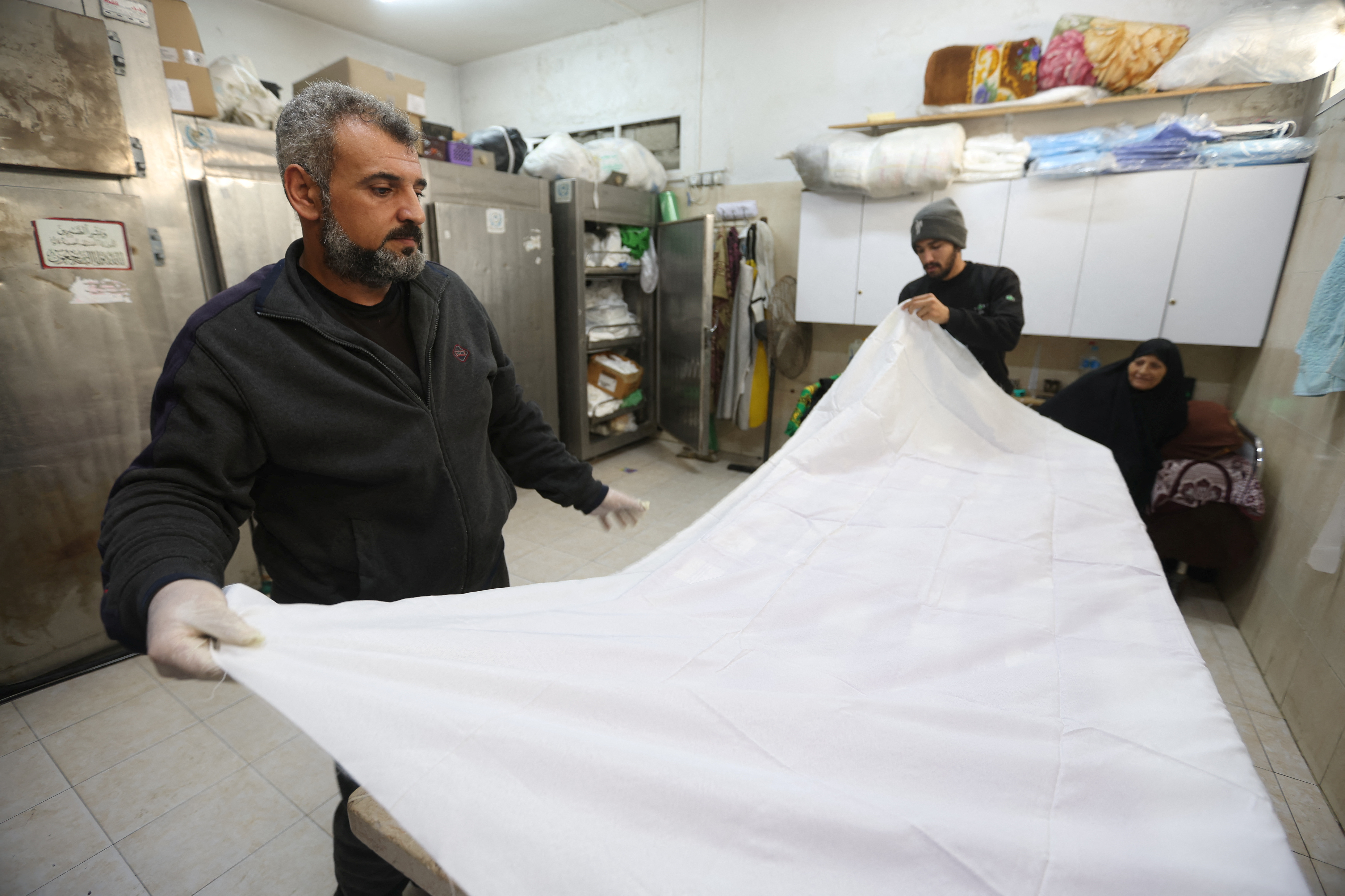 In Gaza, rows of white shrouds symbolize mounting civilian deaths