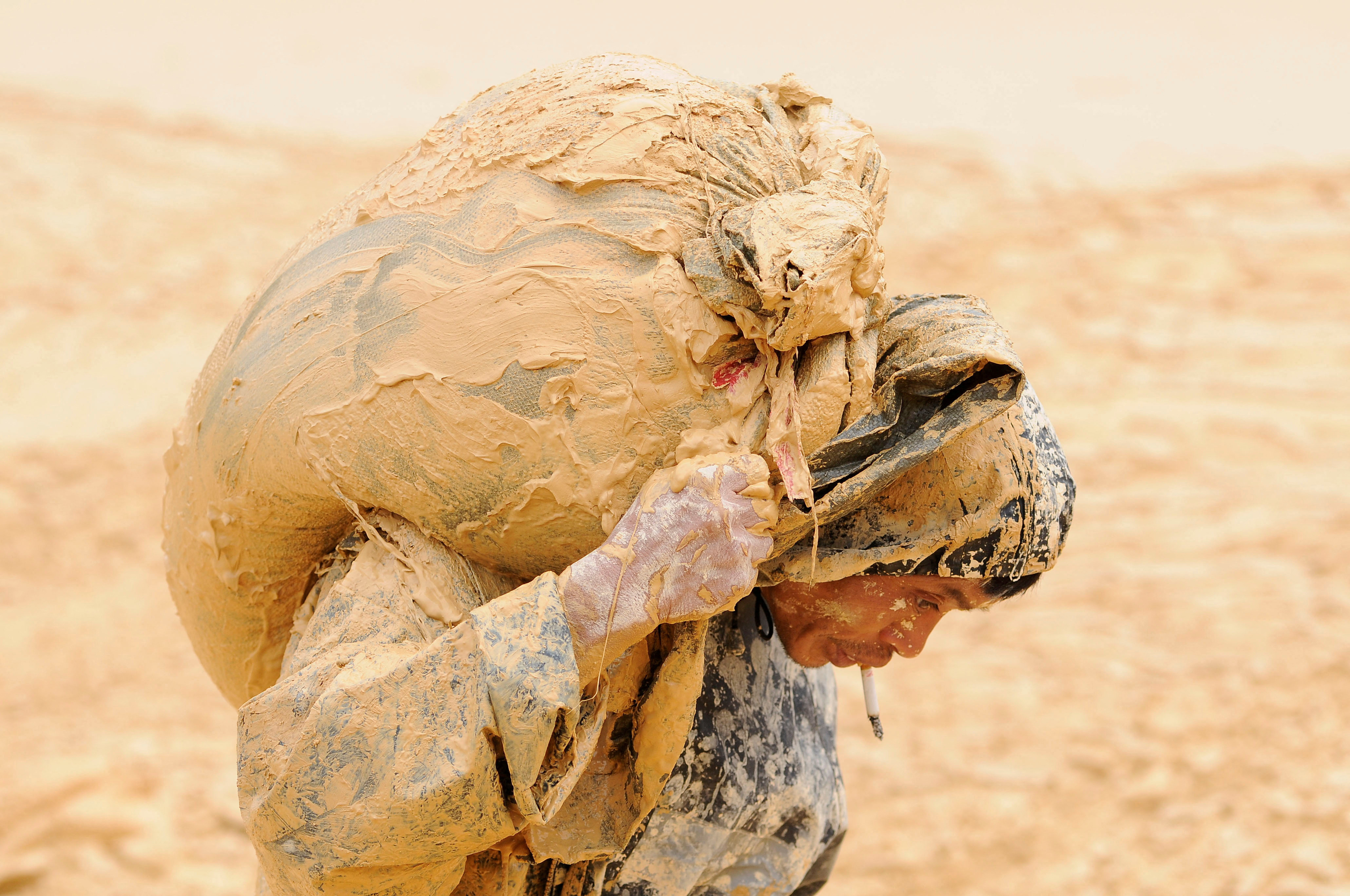 FILE PHOTO: A man works at the site of a rare earth metals mine at Nancheng county