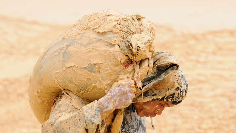 FILE PHOTO: A man works at the site of a rare earth metals mine at Nancheng county