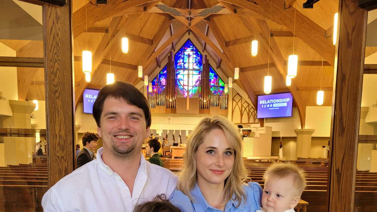 Taras Atamanchuk with his daughter Violet and wife Viktoria attend his son Maximilian's baptism at a church in Sugar Land, Texas