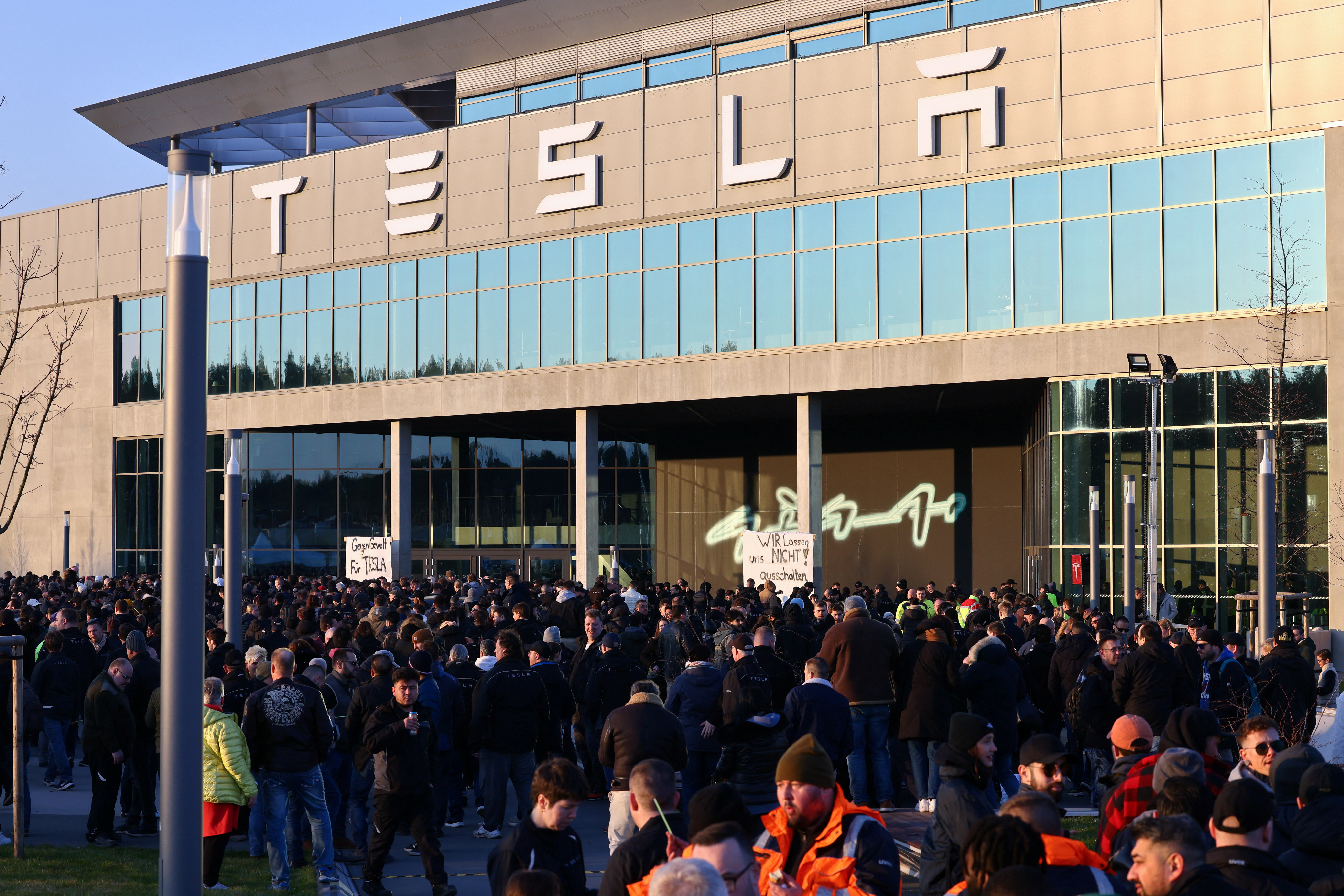 Workers of Tesla's plant protest against an arson attack that has caused a major power outage at Gigafactory in Gruenheide