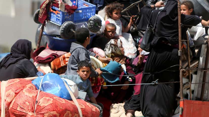 Palestinians make their way after fleeing areas around the southern city of Rafah, following an Israeli evacuation order, in Khan Younis