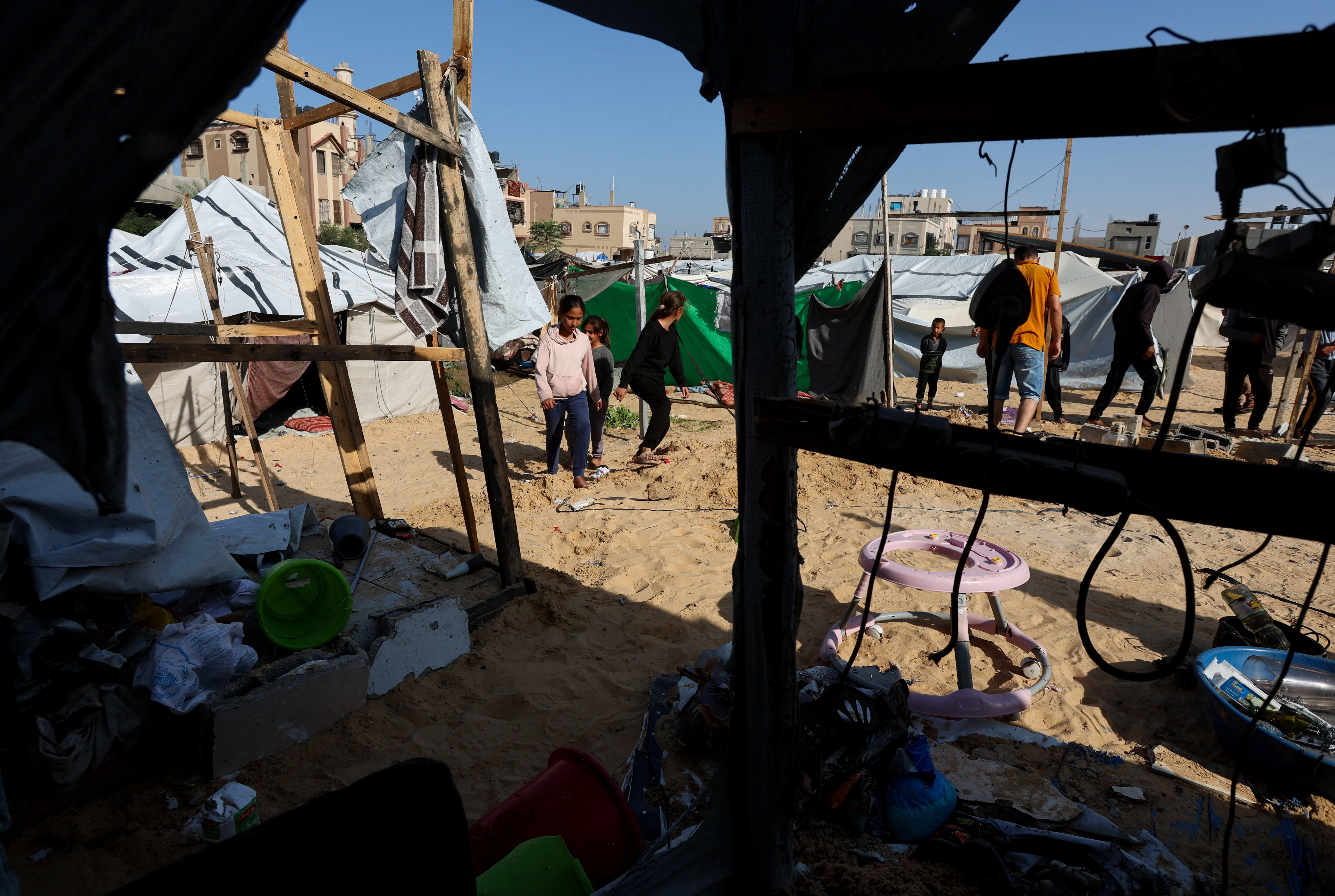 Palestinians inspect the site of Wednesday's Israeli strike on a tents in Al Mawasi