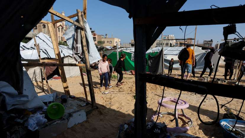 Palestinians inspect the site of Wednesday's Israeli strike on a tents in Al Mawasi