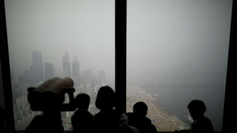 Children look out at a view of Seoul shrouded by heavy smog in Seoul