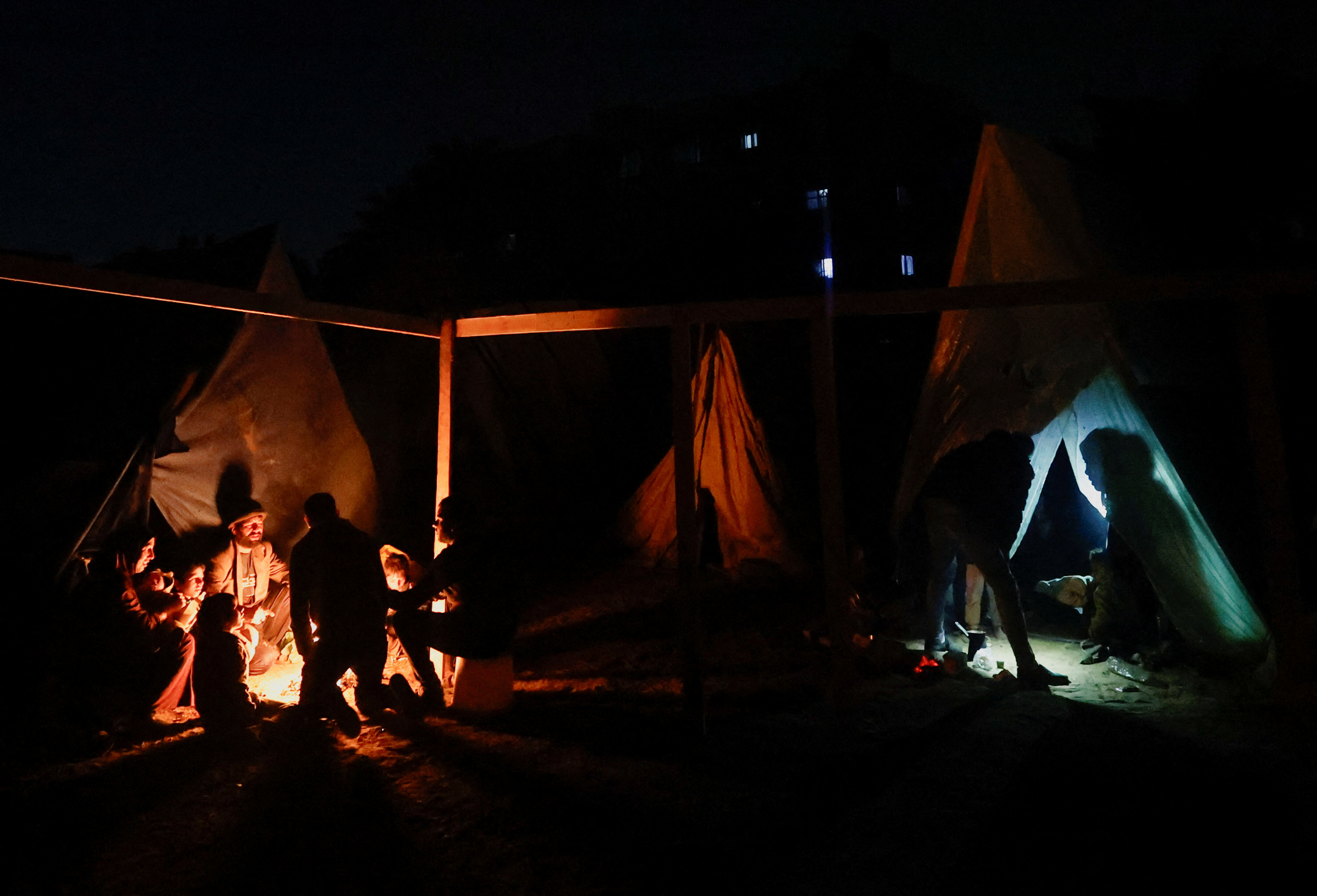 Palestinians who fled their houses due to Israeli strikes shelter in a tent, in Rafah