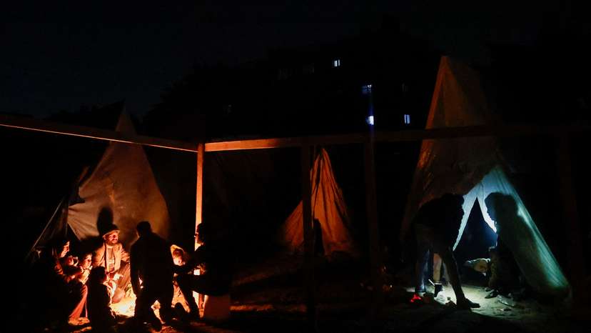 Palestinians who fled their houses due to Israeli strikes shelter in a tent, in Rafah