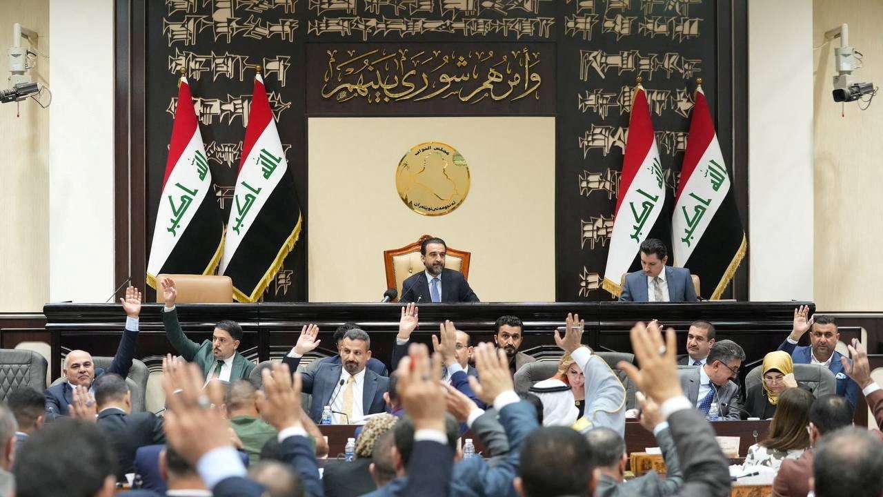 FILE PHOTO: Iraqi lawmakers attend a parliamentary session to vote on the federal budget at the parliament headquarters in Baghdad