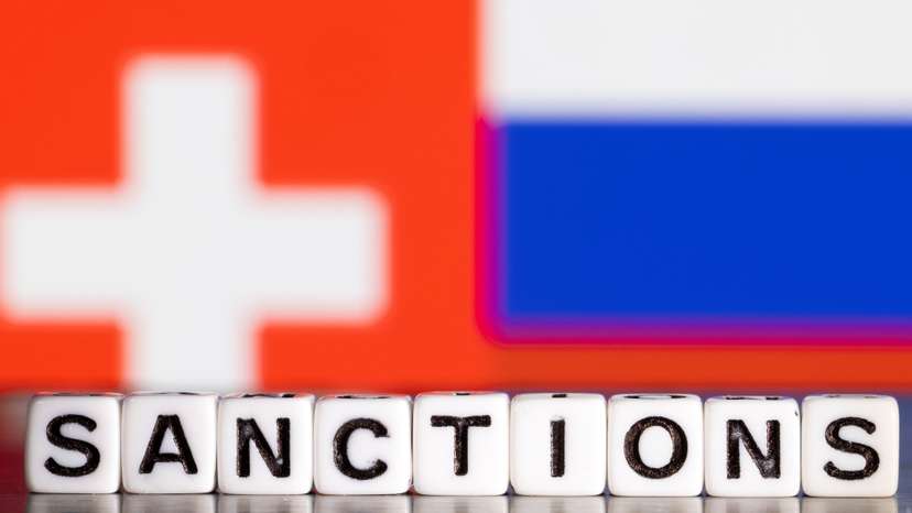 Illustration shows letters arranged to read "Sanctions" in front of flag colors of Switzerland and Russia