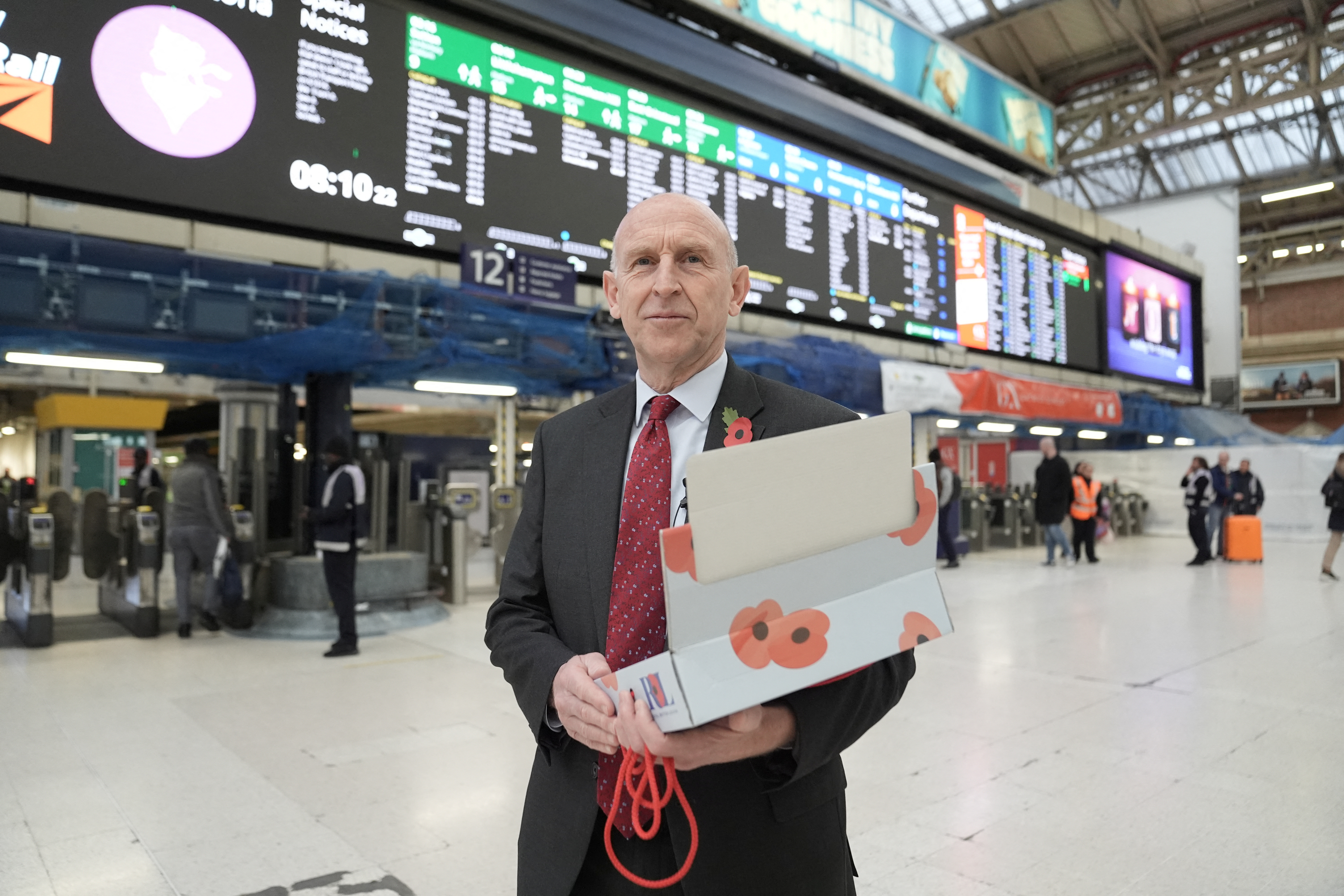 Britain's Defence Secretary John Healey hands out poppies, during London Poppy Day