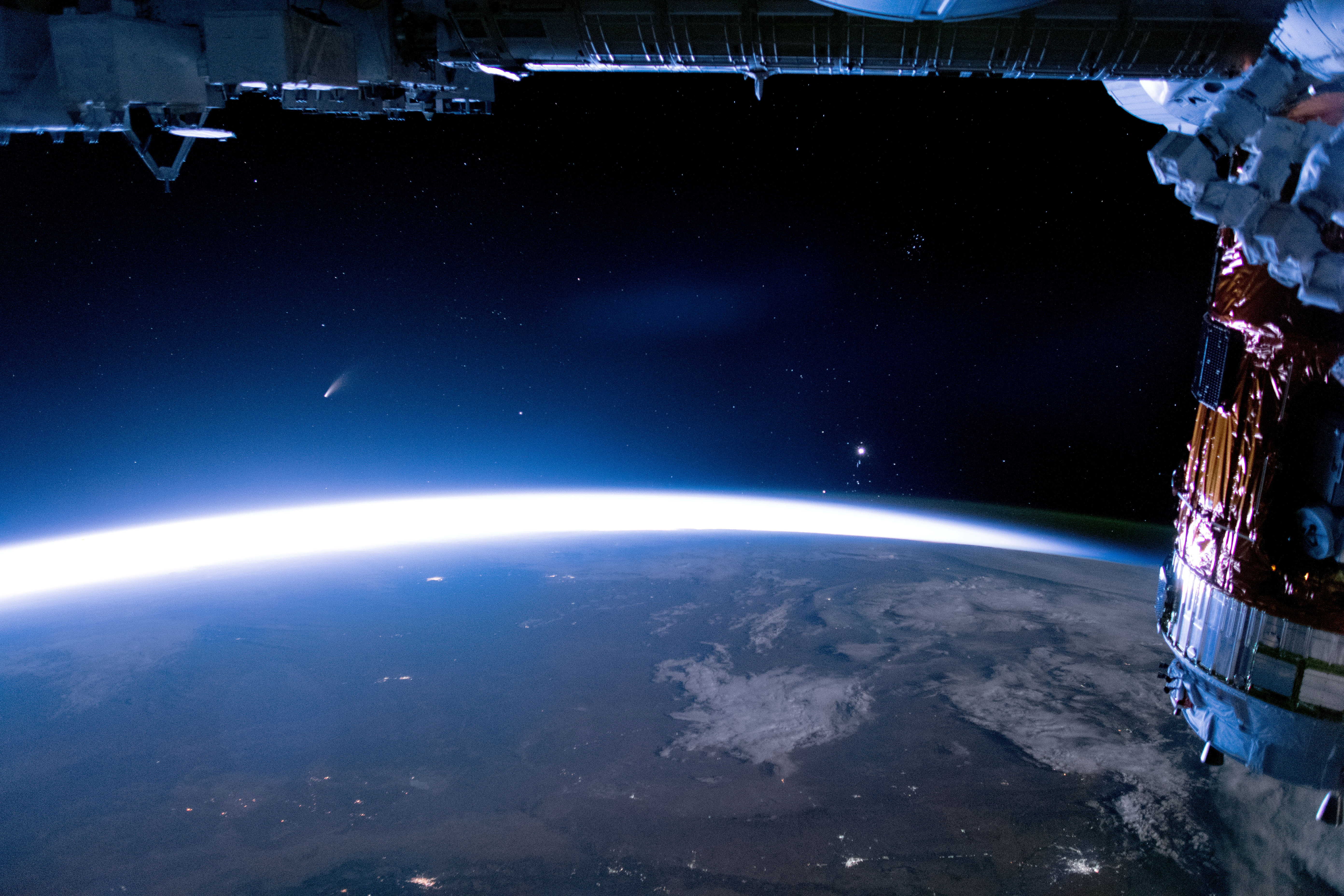 The comet NEOWISE streaks above Earth