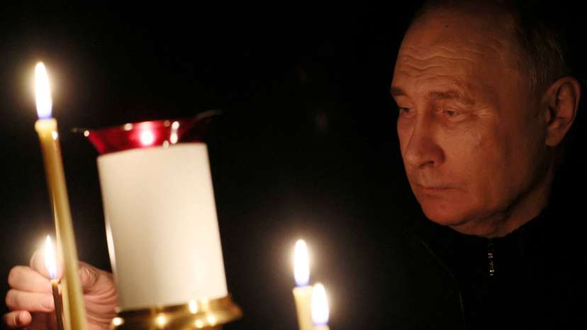FILE PHOTO: Russian President Putin lights a candle in memory of the victims of the Crocus City Hall attack, in Moscow Region