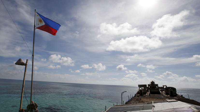 A Philippine flutters on BRP Sierra Madre, a dilapidated Philippine Navy ship that has been aground since 1999, on the disputed Second Thomas Shoal, part of the Spratly Islands, in the South China Sea