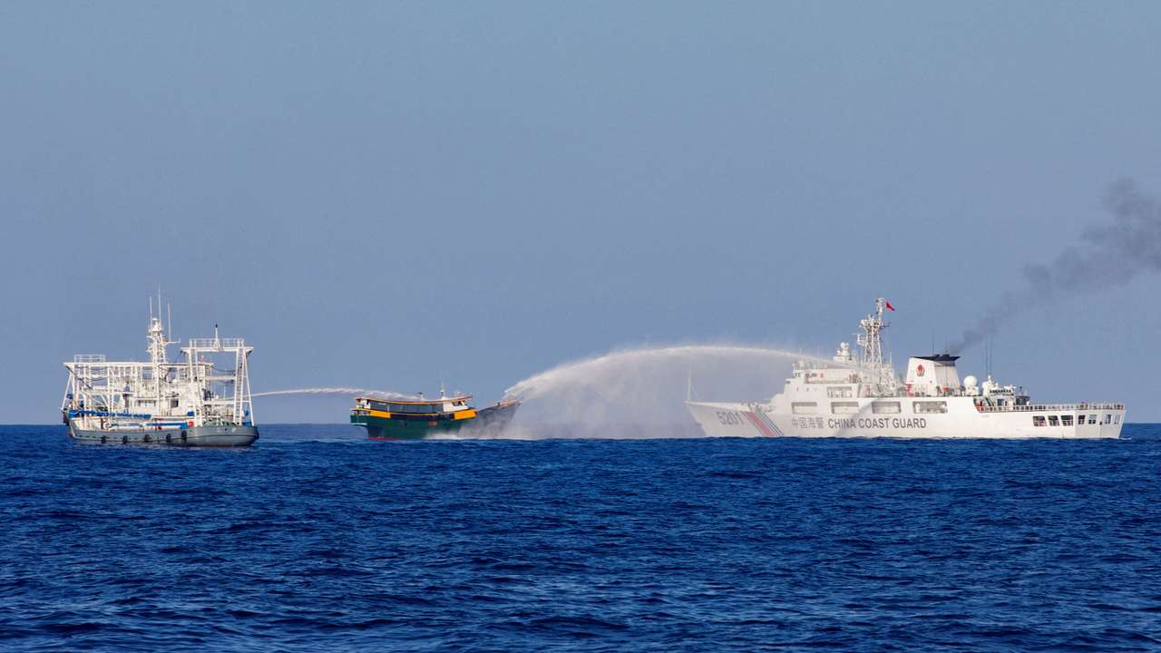 FILE PHOTO: Chinese Coast Guard vessels fire water cannons towards a Philippine resupply vessel Unaizah May 4 on its way to a resupply mission at Second Thomas Shoal in the South China Sea