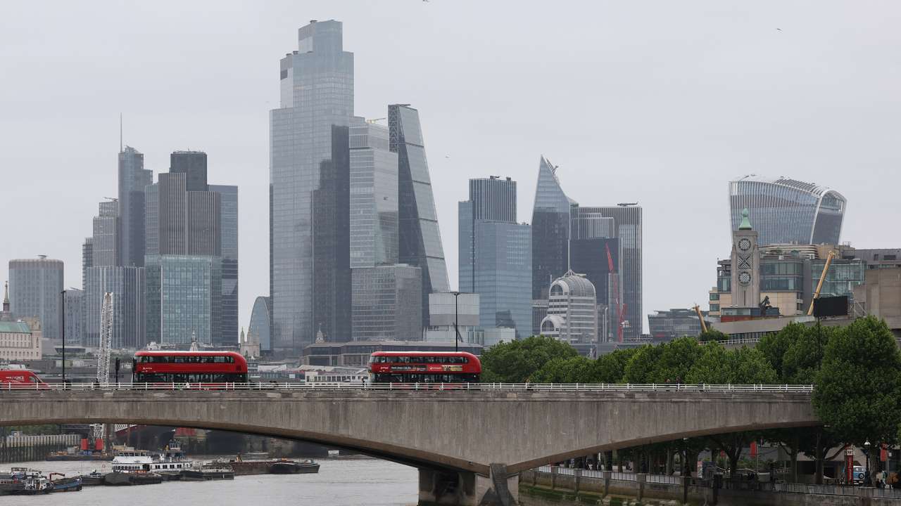 Skyscrapers in the City of London financial district are seen together with St Paul’s Cathedral, in London
