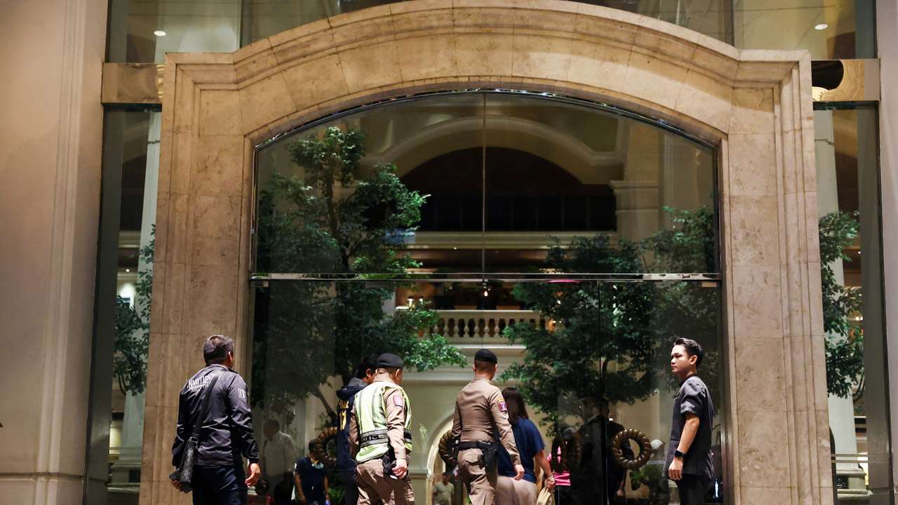 Policemen walk inside Grand Hyatt Erawan hotel, which believed that at least 6 people have been reported dead in Bangkok