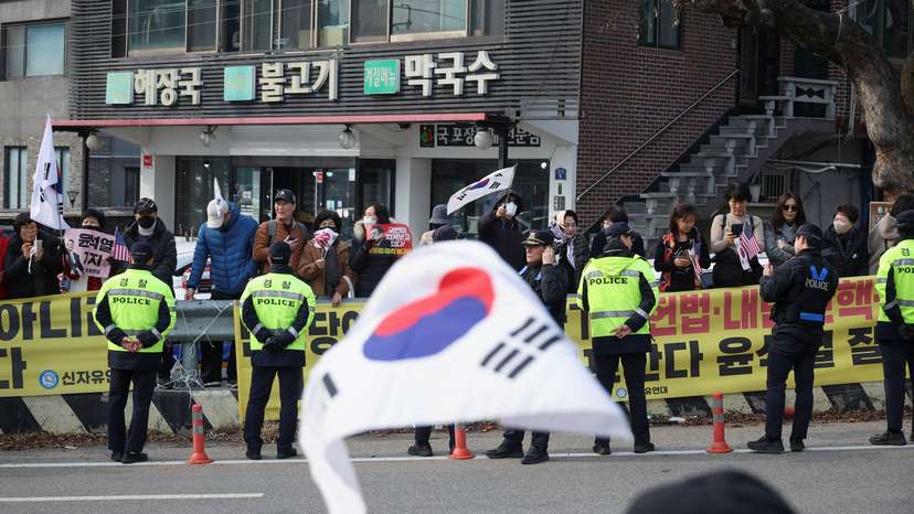 Supporters of South Korean impeached President Yoon Suk Yeol cheer after the court decided to release him, in front of the Seoul detention center in Uiwang