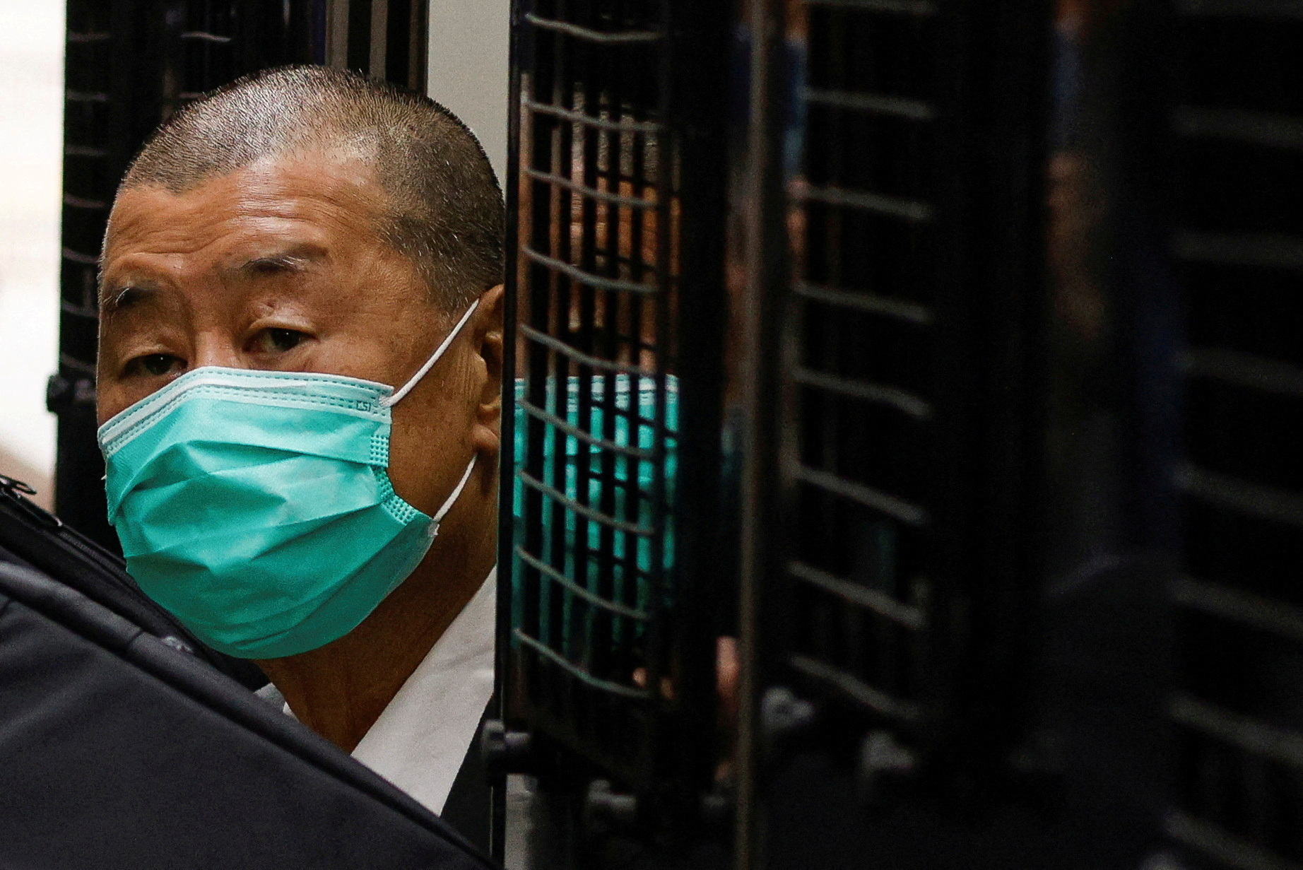 FILE PHOTO: FILE PHOTO: Media mogul Jimmy Lai, founder of Apple Daily, arrives the Court of Final Appeal by prison van in Hong Kong