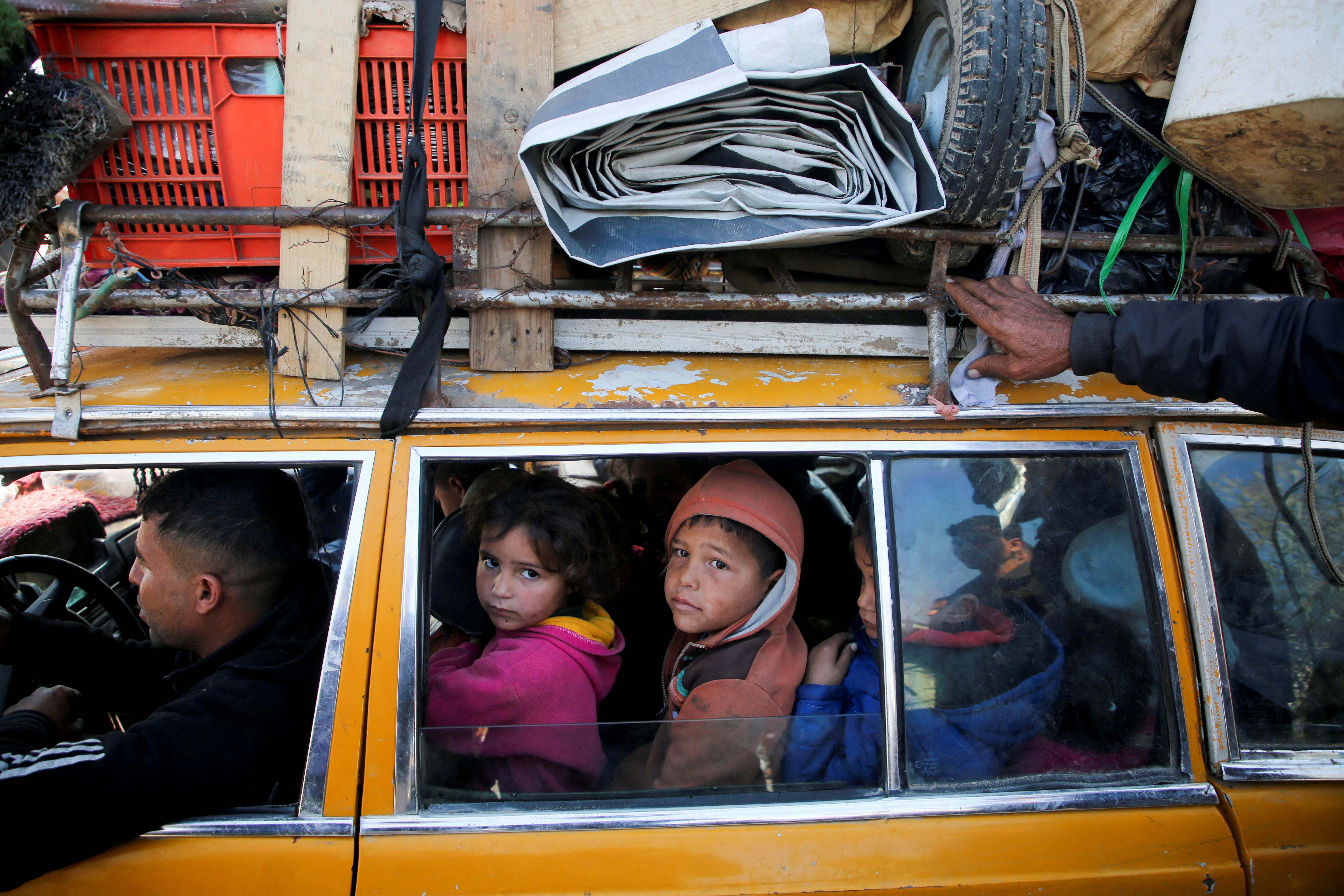 Displaced Palestinians make their way back to their homes in northern Gaza, amid a ceasefire between Israel and Hamas, in the central Gaza Strip