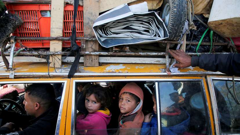 Displaced Palestinians make their way back to their homes in northern Gaza, amid a ceasefire between Israel and Hamas, in the central Gaza Strip