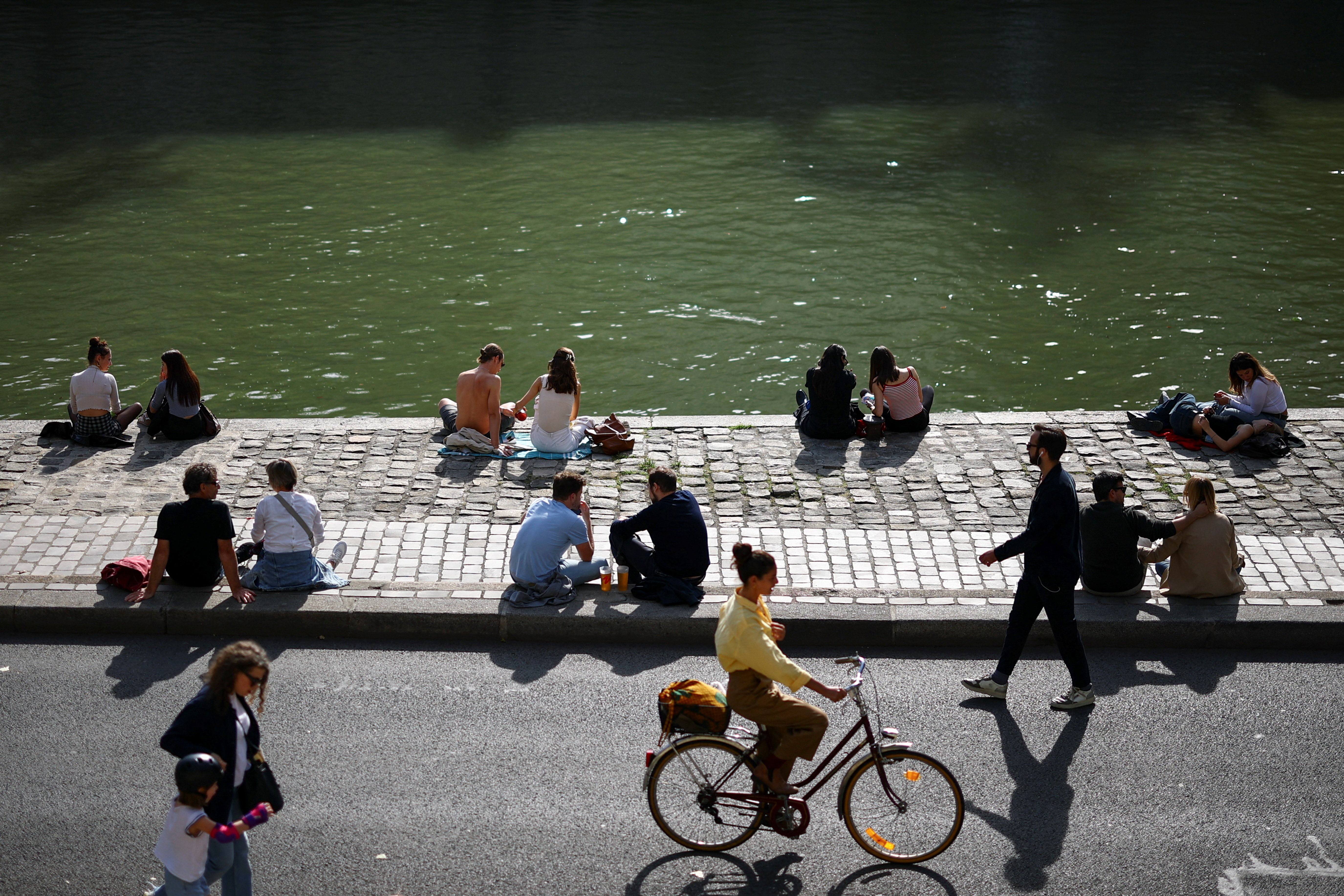 People enjoy a sunny day in Paris