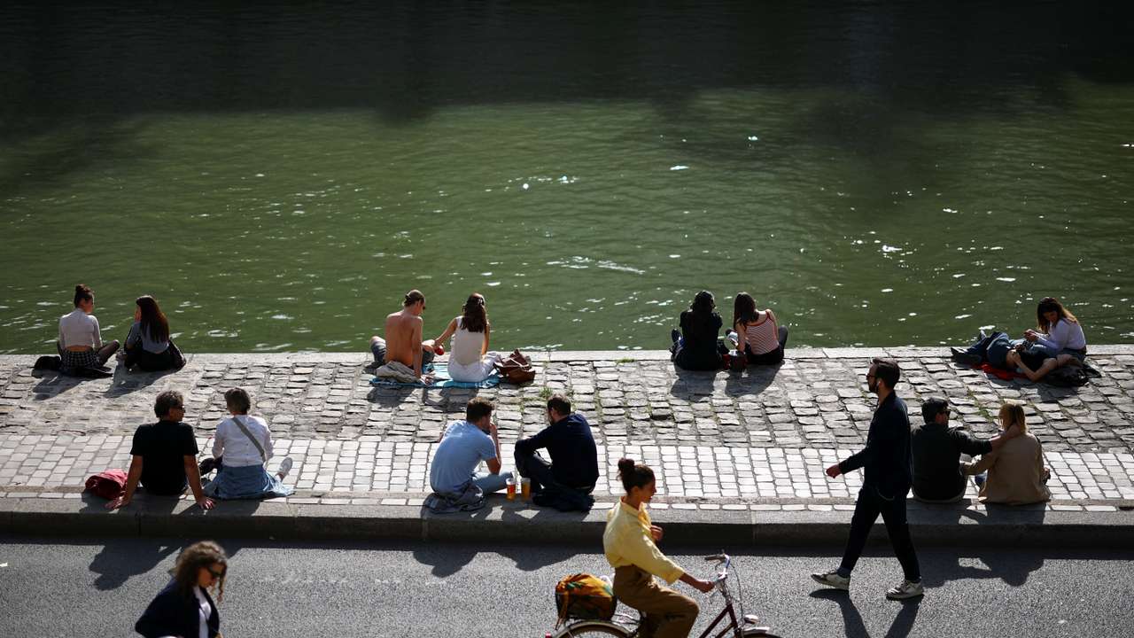 People enjoy a sunny day in Paris