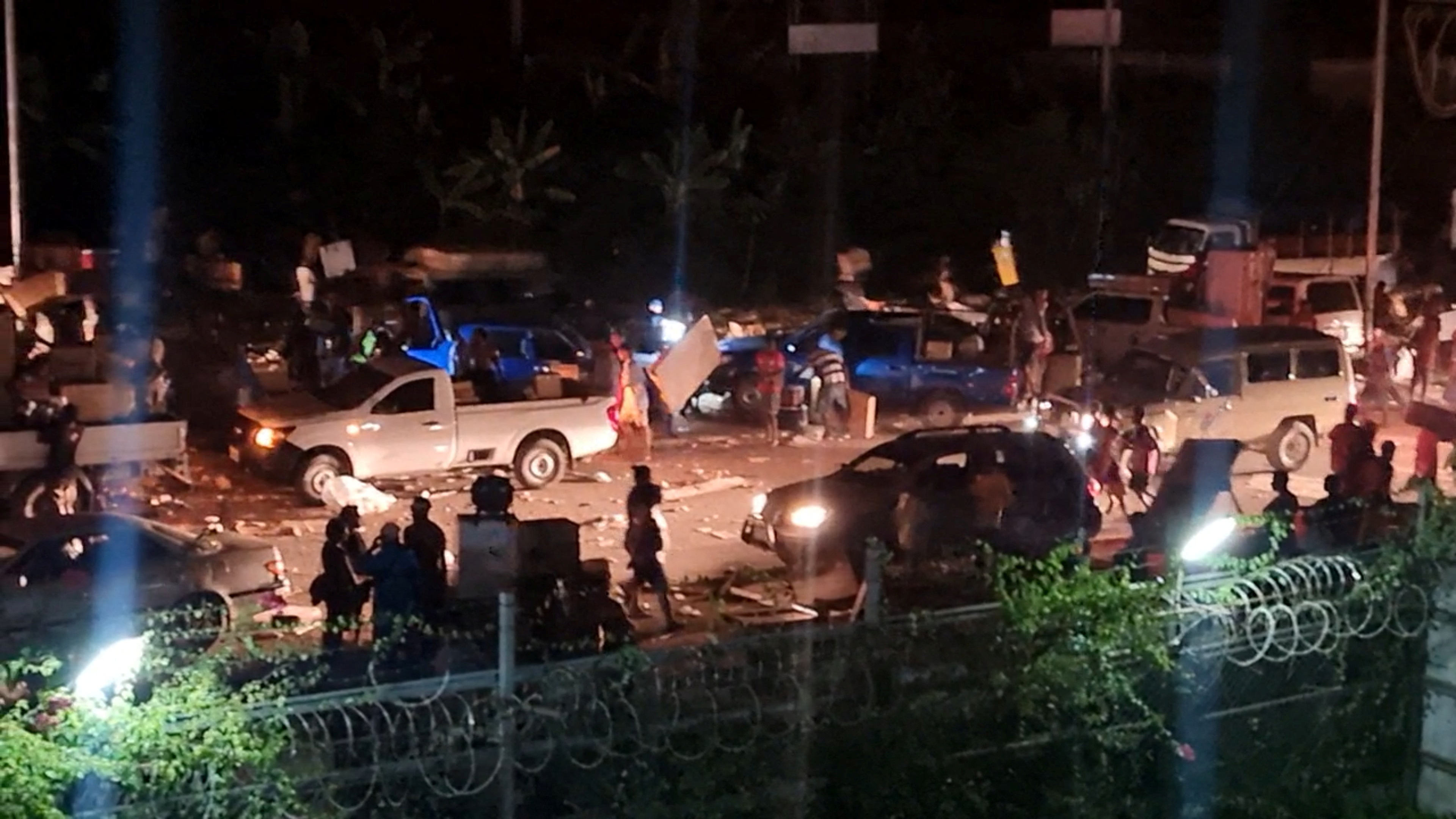 People take part in looting and arson amid protests over a pay cut for police that officials blamed on an administrative glitch, in Port Moresby