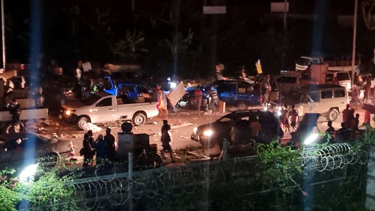 People take part in looting and arson amid protests over a pay cut for police that officials blamed on an administrative glitch, in Port Moresby