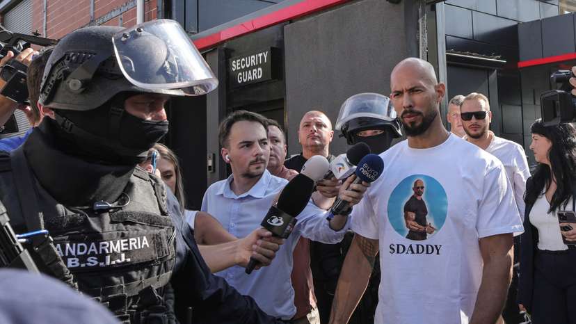 Romanian Gendarmes escort Andrew and Tristan Tate, outside the Tate brothers' residence in Pipera