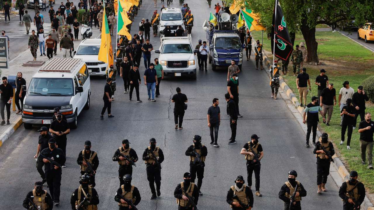 FILE PHOTO: A vehicle carries the coffin of a commander from Iraq's Kataib Hezbollah armed group, in Baghdad