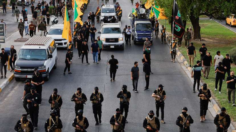 FILE PHOTO: A vehicle carries the coffin of a commander from Iraq's Kataib Hezbollah armed group, in Baghdad