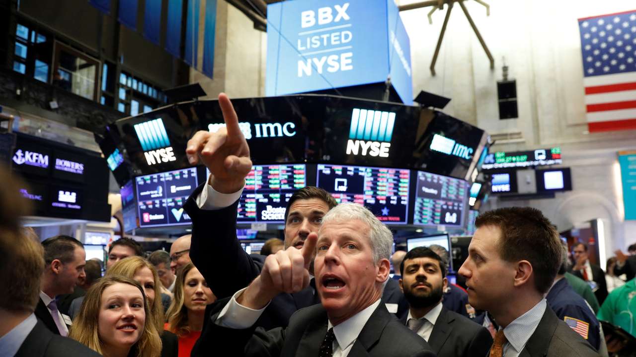Liberty Oilfield Services Inc. CEO Chris Wright (C) talks with NYSE Group President Thomas Farley while waiting for the companies IPO on the floor of the New York Stock Exchange shortly after the opening bell in New York