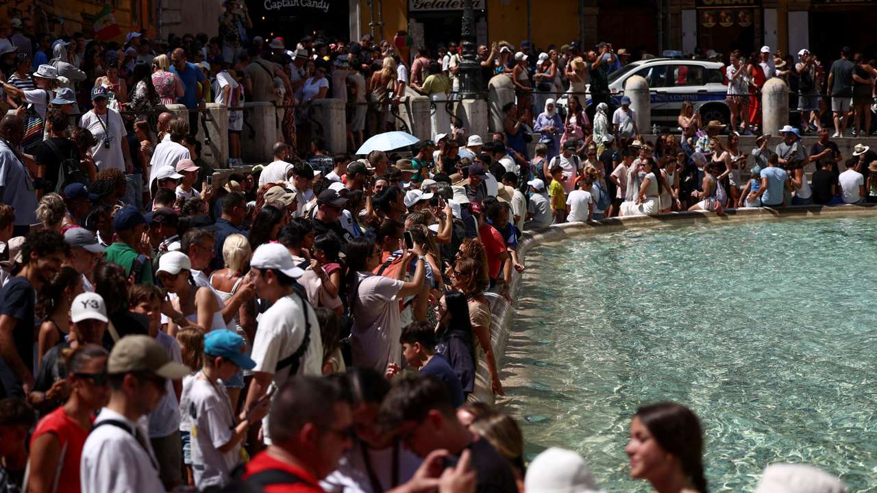 FILE PHOTO: Crowds of tourists visit the Trevi Fountain in Rome