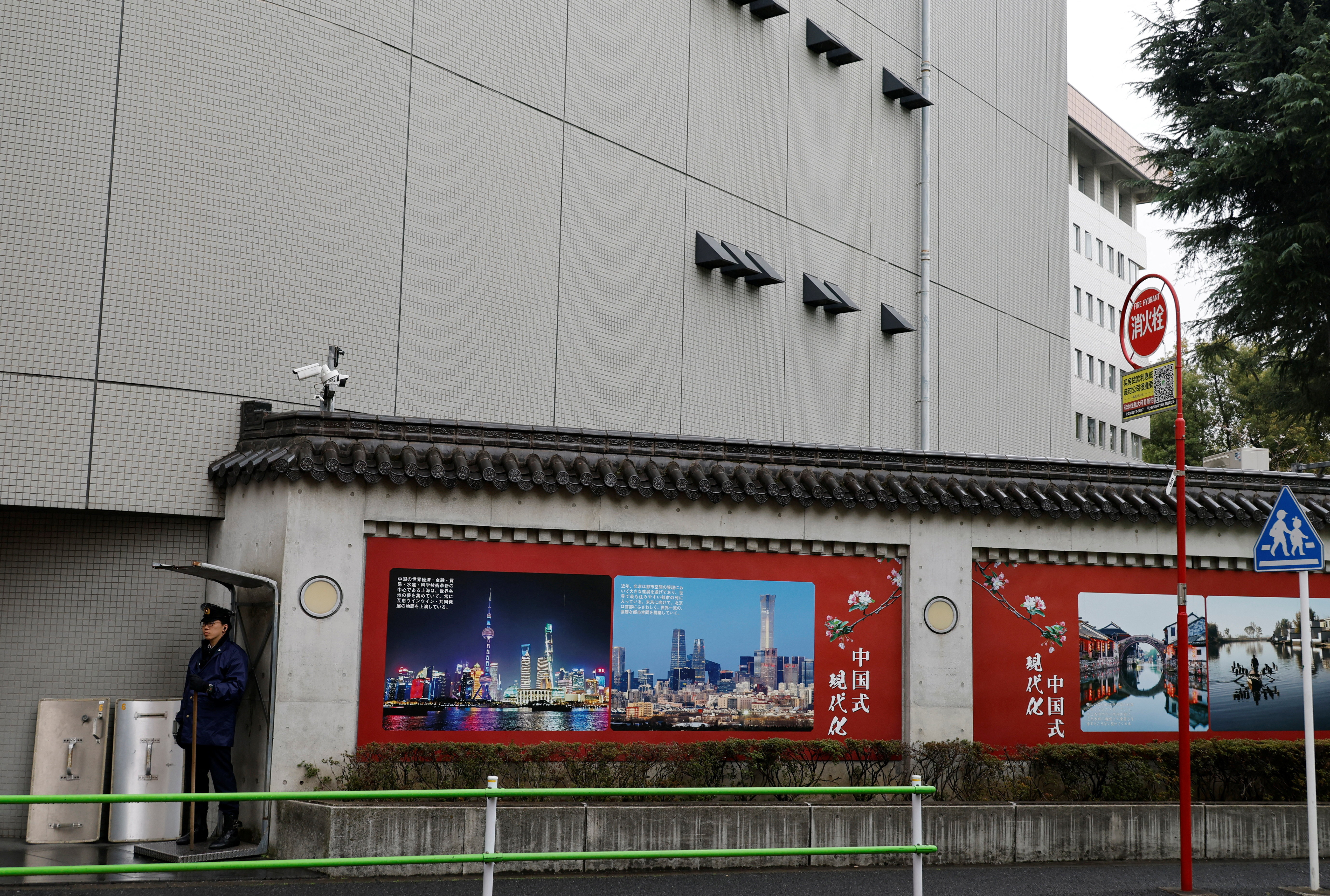 A Japanese police officer stands guard in front of the Chinese Embassy in Tokyo
