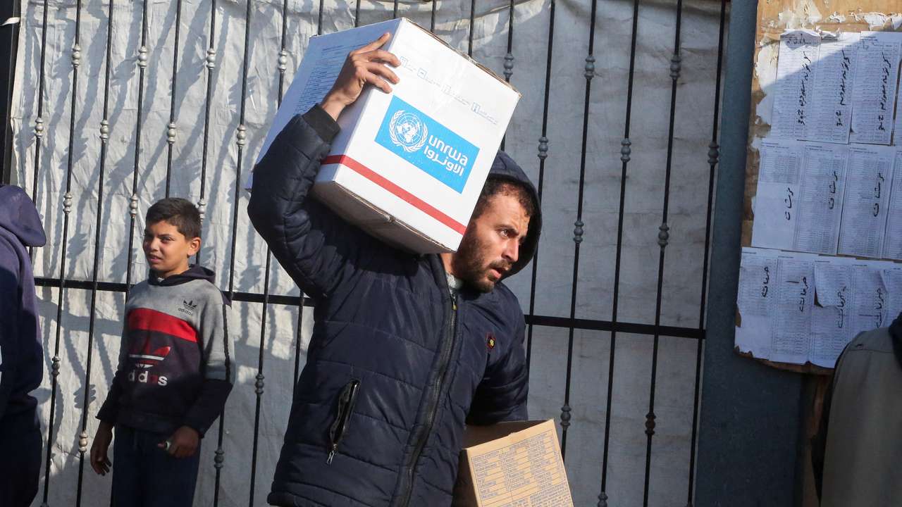 Palestinians receive aid from UNRWA in Khan Younis in the southern Gaza Strip