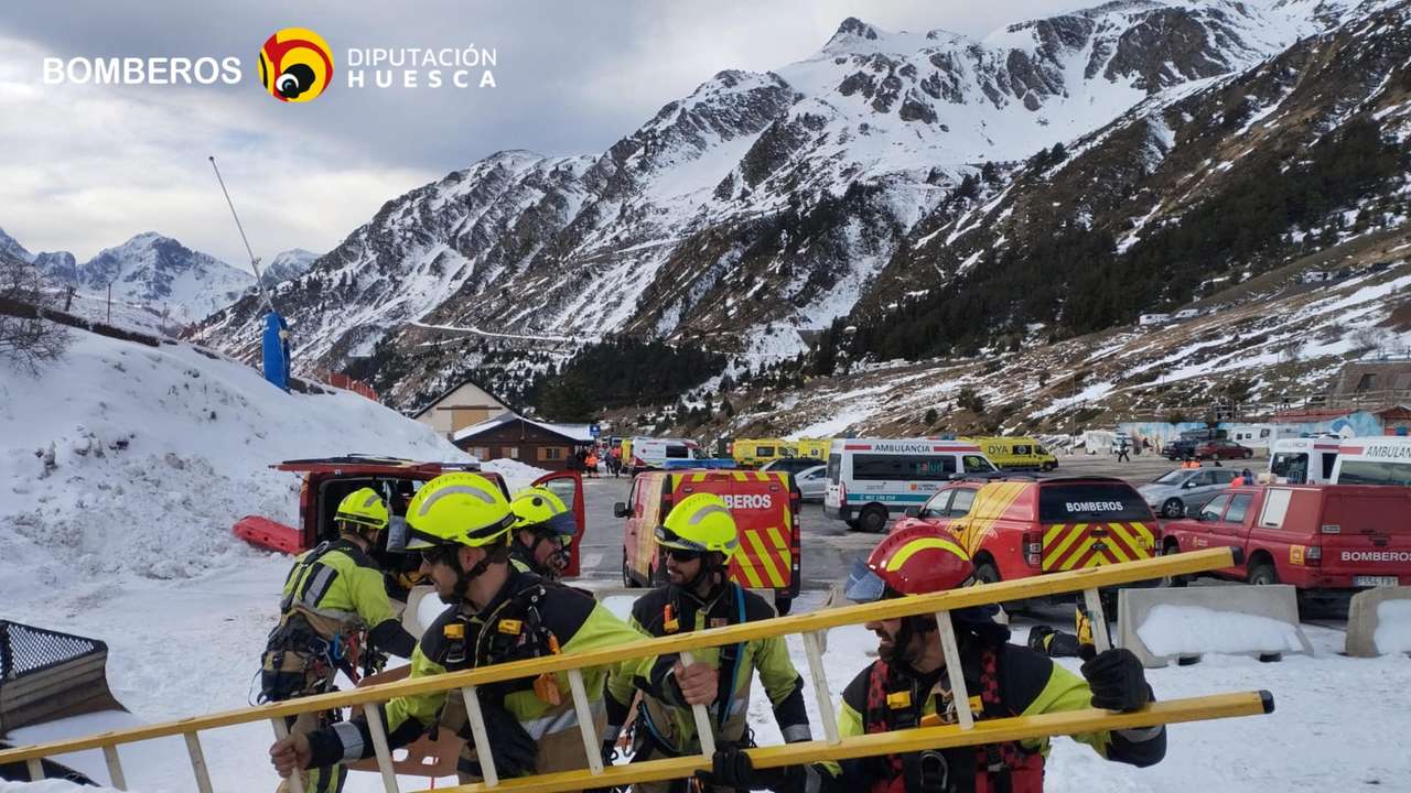 Firefighters work during a rescue operation following a chairlift accident in the Astun ski resort in Huesca
