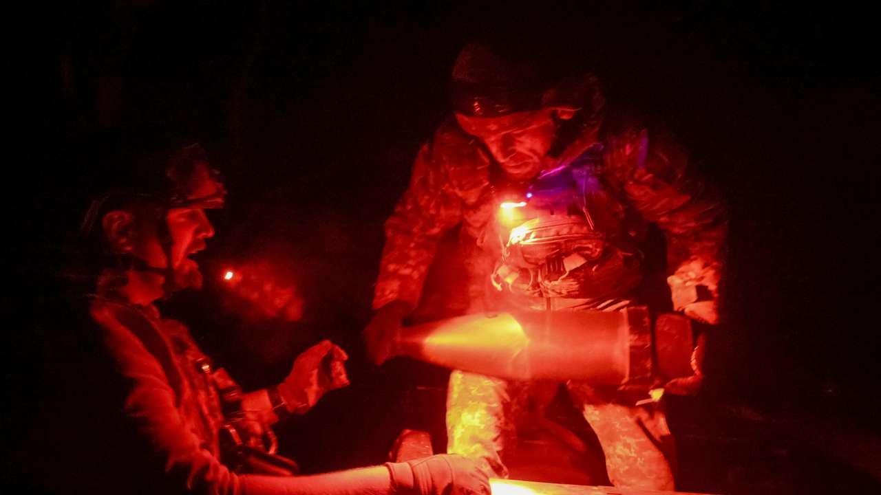 Ukrainian servicemen unload shells for a self-propelled howitzer near the frontline town of Pokrovsk